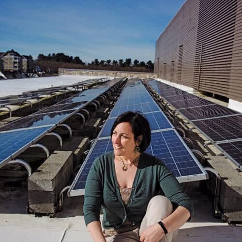 Leah Miller, Energy Manager of the Office of Community Sustainability, 
on the solar paneled roof of the Miller Library (no relation).